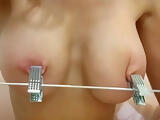 Nipples tied tight with rubber bands clamped with hanger great close up