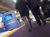 Candid mature in black pantyhose heels walking in expo